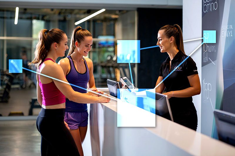 Gym membership management with TVI Gym employee checking in a member and member guest at front desk using TVI integrated POS and CRM system.